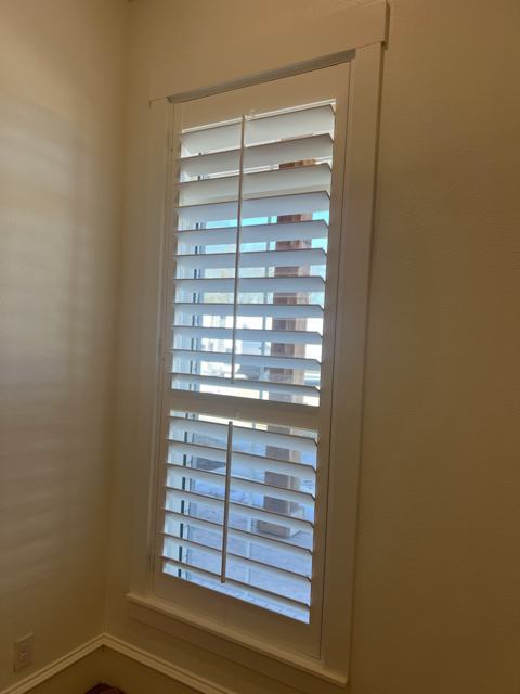 Tall plantation shutters on a corner window