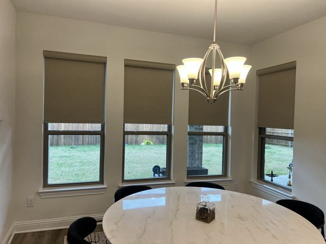 Roller shades over a dining nook